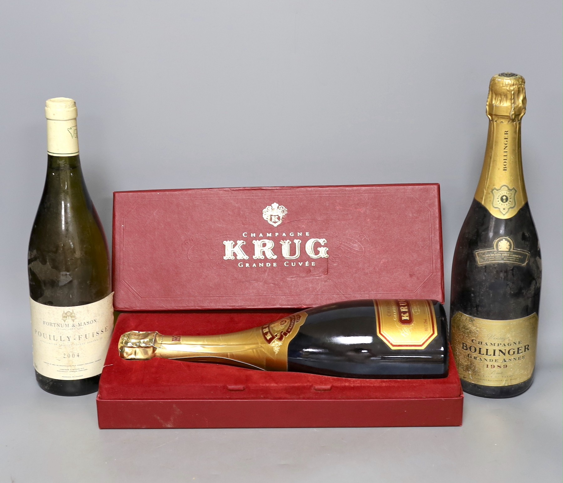 One bottle of Bollinger vintage champagne, 1989, one boxed bottle of Krug (NV) and a bottle of 2004 Pouilly Fuisse